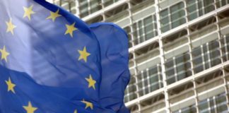Bandera de la UE delante de un edificio comunitario.