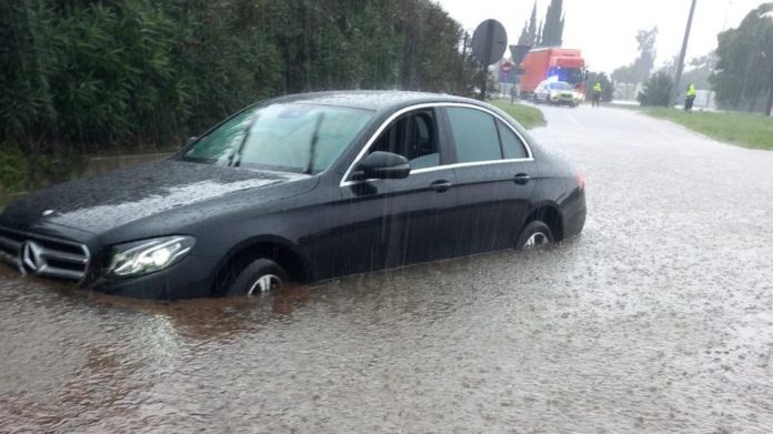 Un coche atascado en una carretera catalana inundada por las fuertes lluvias de la DANA