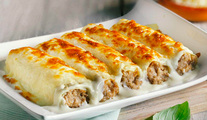 Canelones caseros de Sant Esteve recién horneados con bechamel dorada y queso gratinado.