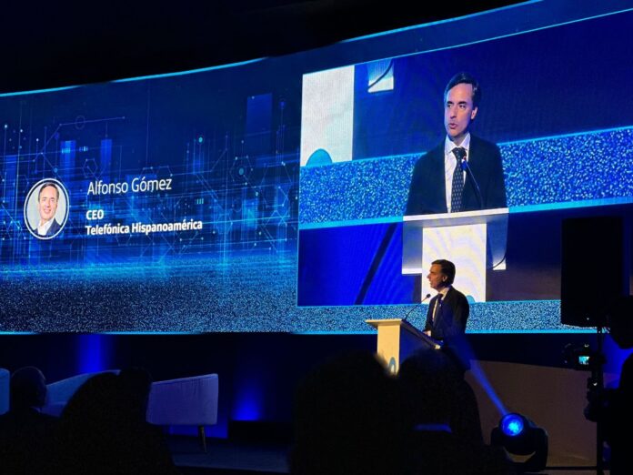 Alfonso Gómez Palacio en una charla en un escenario del mismo color que el logo de Telefónica.