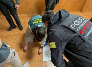 Agentes de los Mossos d'Esquadra y la Guardia Civil inspeccionan joyas robadas recuperadas en el suelo durante la operación contra la banda de alunizajes.