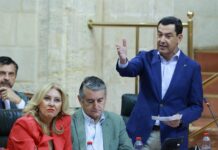 El presidente de Andalucía, Juanma Moreno, en una intervención en el Parlamento andaluz junto a diputados del PP.